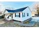 White house with brick base, covered porch, and rocking chair at 1105 Mount Olivet Rd, Kannapolis, NC 28083