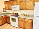 Galley kitchen with wood cabinets and modern appliances at 1105 Mount Olivet Rd, Kannapolis, NC 28083