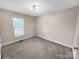 Spacious bedroom featuring neutral carpeting and large window at 1107 Phifer Rd, Kings Mountain, NC 28086