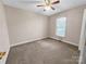 Well-lit bedroom with ceiling fan and neutral carpeting at 1107 Phifer Rd, Kings Mountain, NC 28086