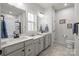 Bathroom with double sink vanity, white countertops and cabinets, with framed mirrors at 1112 Augustus Beamon Dr, Indian Trail, NC 28079