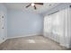 Bedroom features light blue walls, carpeting, and a ceiling fan at 1112 Augustus Beamon Dr, Indian Trail, NC 28079