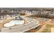 A birds eye view of the community swimming pool, playground, parking, and tennis court at 1112 Augustus Beamon Dr, Indian Trail, NC 28079