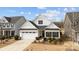 Charming home exterior featuring a two-car garage and well-manicured landscaping at 1112 Augustus Beamon Dr, Indian Trail, NC 28079