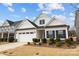 Exterior of a charming white home with manicured landscaping and attached garage at 1112 Augustus Beamon Dr, Indian Trail, NC 28079