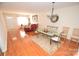 Dining area with hardwood floors and glass-top table at 11646 Rabbit Ridge Rd, Charlotte, NC 28270