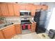 Stainless steel appliances and wood cabinets in this kitchen at 11646 Rabbit Ridge Rd, Charlotte, NC 28270