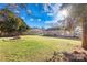 Sunny backyard featuring a fire pit and grassy yard at 11816 Park Rd, Charlotte, NC 28226