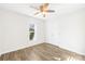 Well-lit bedroom with double door closet and ceiling fan at 11816 Park Rd, Charlotte, NC 28226