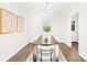 Bright dining room with hardwood floors and modern light fixture at 11816 Park Rd, Charlotte, NC 28226