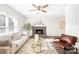 Spacious living room featuring a fireplace and large windows at 11816 Park Rd, Charlotte, NC 28226