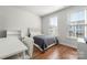 Bright bedroom with hardwood floors and a workspace at 11936 Fiddlers Roof Ln, Charlotte, NC 28277