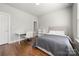 Well-lit bedroom with hardwood floors and a cozy bed at 11936 Fiddlers Roof Ln, Charlotte, NC 28277