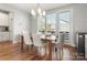 Bright dining room with wooden table and white chairs near sliding doors at 11936 Fiddlers Roof Ln, Charlotte, NC 28277