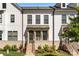 Contemporary townhouse with gray door and brick walkway at 11936 Fiddlers Roof Ln, Charlotte, NC 28277