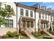 Modern white townhouses with brick accents and landscaping at 11936 Fiddlers Roof Ln, Charlotte, NC 28277