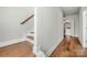 Bright hallway with hardwood floors and staircase at 11936 Fiddlers Roof Ln, Charlotte, NC 28277