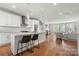 Open concept kitchen with white cabinets and island, overlooking living room at 11936 Fiddlers Roof Ln, Charlotte, NC 28277