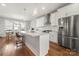 Modern kitchen with white cabinets, island, and stainless steel appliances at 11936 Fiddlers Roof Ln, Charlotte, NC 28277