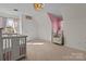 Bright bedroom with a crib, armchair, and neutral color palette at 1212 Ridge St, Albemarle, NC 28001