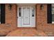 White front door with brick walkway and black shutters at 1212 Ridge St, Albemarle, NC 28001