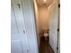 This half bath features wood floors and a toilet at 12131 Plummer Ct # 1, Midland, NC 28107