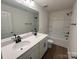 Bathroom with double sink vanity, shower, and bath tub with white cabinets and modern fixtures at 12131 Plummer Ct # 1, Midland, NC 28107