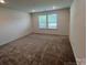 This carpeted bedroom features natural light from a double window at 12131 Plummer Ct # 1, Midland, NC 28107