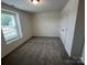 Cozy bedroom with plush carpeting, a large window, and a closet with a white door at 12131 Plummer Ct # 1, Midland, NC 28107