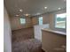 Upstairs bonus room with plush carpet and natural light from two windows overlooking the neighborhood at 12131 Plummer Ct # 1, Midland, NC 28107