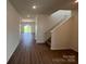 Bright entryway featuring wood-look floors leading to an open floor plan and staircase at 12131 Plummer Ct # 1, Midland, NC 28107