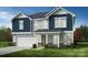 Two-story home with blue and gray siding, a white door, and a two-car garage at 12131 Plummer Ct # 1, Midland, NC 28107