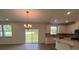 Open concept kitchen with white cabinets, modern appliances, and wood-look floors at 12131 Plummer Ct # 1, Midland, NC 28107