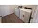 Laundry room features wood-look floors and new washer and dryer units at 12131 Plummer Ct # 1, Midland, NC 28107