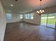 Spacious living room with wood-look floors, recessed lighting, and a sliding door to the backyard at 12131 Plummer Ct # 1, Midland, NC 28107