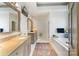 Bathroom featuring double vanity, soaking tub and natural light at 12201 Pine Valley Club Dr, Charlotte, NC 28277