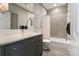 Modern bathroom featuring a gray vanity, tile flooring, and combined shower and tub at 12201 Pine Valley Club Dr, Charlotte, NC 28277