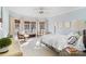 Sunlit bedroom with a four-poster bed, neutral tones, and many windows at 12201 Pine Valley Club Dr, Charlotte, NC 28277