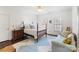 Light-filled bedroom with wood floors, four-poster bed, and decorative accents at 12201 Pine Valley Club Dr, Charlotte, NC 28277