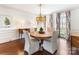 Formal dining room with elegant chandelier, hardwood floors, and natural light at 12201 Pine Valley Club Dr, Charlotte, NC 28277