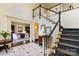 Spacious foyer featuring a staircase, marble flooring, and an inviting view into the living room at 12201 Pine Valley Club Dr, Charlotte, NC 28277