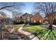 Beautiful brick home featuring a meticulously landscaped front yard and inviting walkway at 12201 Pine Valley Club Dr, Charlotte, NC 28277