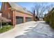 Exterior view of the home's two-car garage, complete with a wide driveway and a well-maintained brick facade at 12201 Pine Valley Club Dr, Charlotte, NC 28277