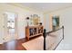 Bright hallway with hardwood floors, decorative mirror, and views into other rooms at 12201 Pine Valley Club Dr, Charlotte, NC 28277