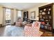 Charming living room featuring hardwood floors, built-in bookshelves, and comfortable armchairs at 12201 Pine Valley Club Dr, Charlotte, NC 28277