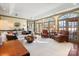 Inviting living room featuring hardwood floors, a fireplace, and French doors at 12201 Pine Valley Club Dr, Charlotte, NC 28277