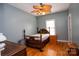 Smaller bedroom with hardwood floors and antique wooden bed frame at 1270 Mirror Lake Rd, Lincolnton, NC 28092