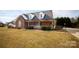 Brick ranch home with stone accents, a large front porch, and a well-manicured lawn at 1270 Mirror Lake Rd, Lincolnton, NC 28092