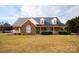 Brick ranch home with stone accents, a large front porch, and a landscaped yard at 1270 Mirror Lake Rd, Lincolnton, NC 28092