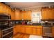 Kitchen with wood cabinets and granite countertops at 1270 Mirror Lake Rd, Lincolnton, NC 28092